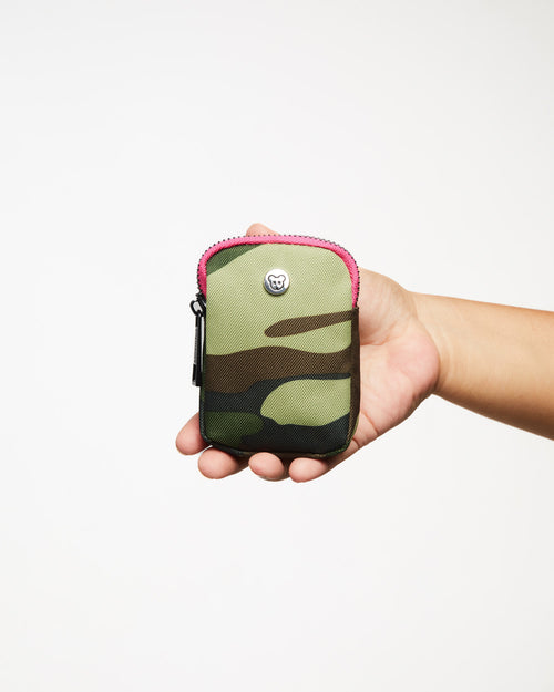 A small camouflage pouch with a pink interior and gold hardware, featuring a clip and a zipper, displayed against a white background.