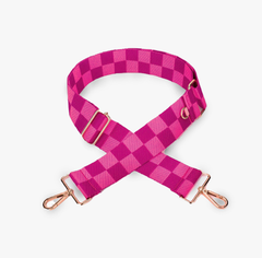Pink checkered bag strap with gold hardware on a white background