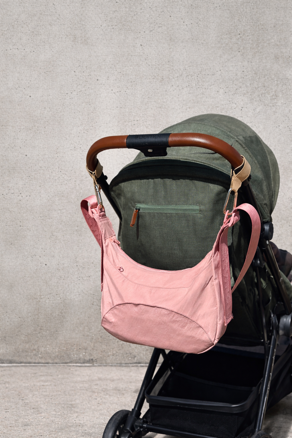 Citymouse NY Park Bag in Baby/ Pink with a plain strap hanging in a stroller