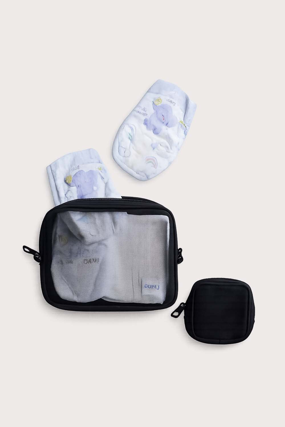 A set of black packing cubes with a transparent front zipper, accompanied by a black paci clip pouch and a spare changing sheet, all branded with 'citymouseny'.
