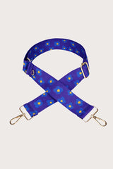 Blue floral-patterned bag strap on a light gray background