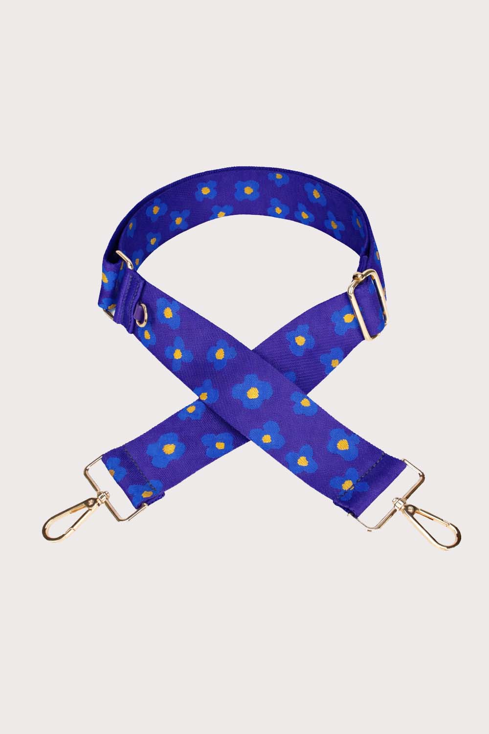 Blue floral-patterned bag strap on a light gray background