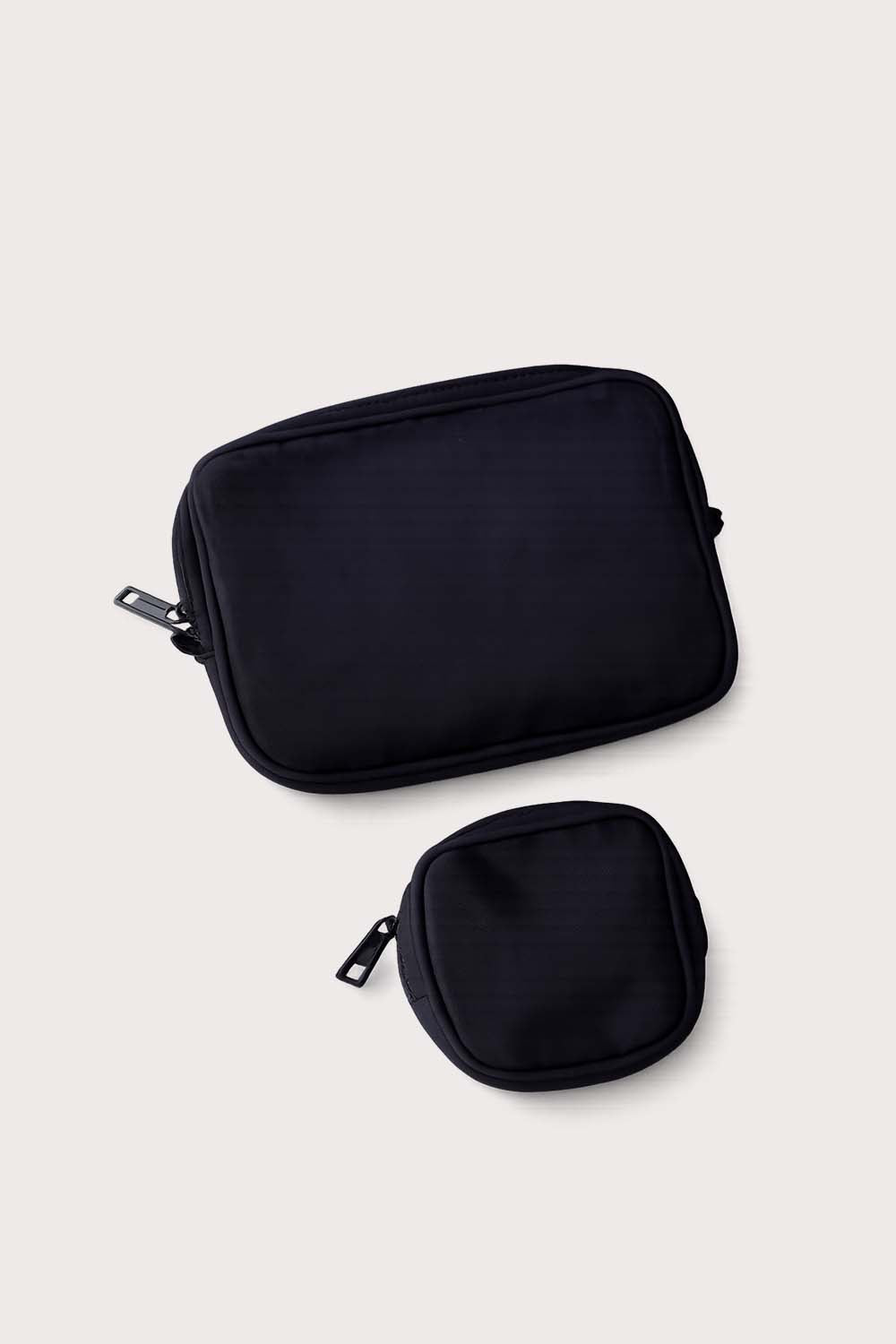 A set of black packing cubes with a  black paci clip pouch  branded with 'citymouseny'.