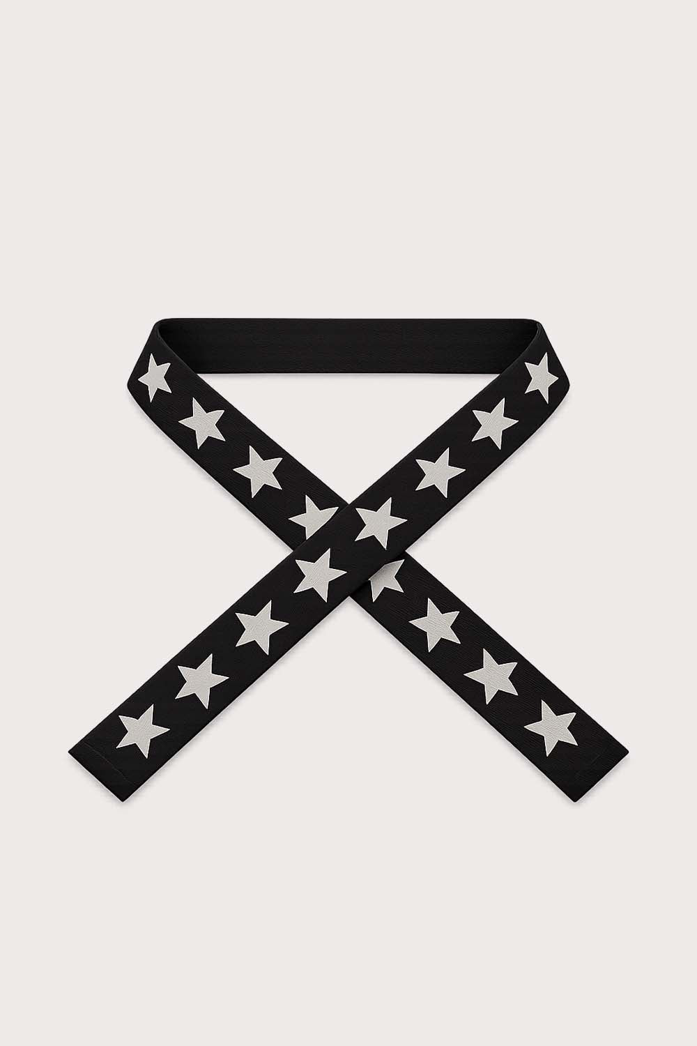 Black with white star patterned Park bag strap on a light gray background