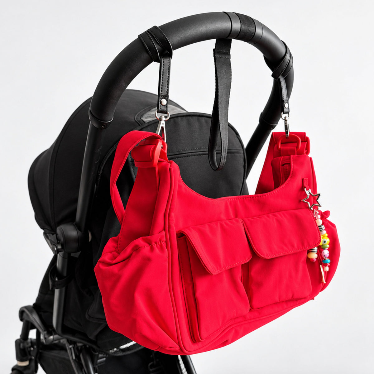 Citymouse Cargo Crossbody Diaper Bag in Maraschino red on a stroller